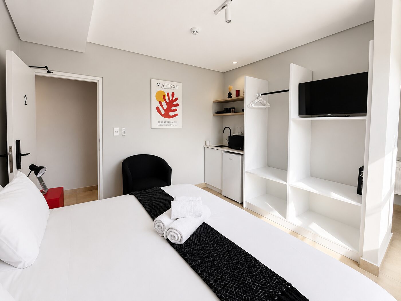 Village Stay studio suite with kitchenette and Matisse artwork